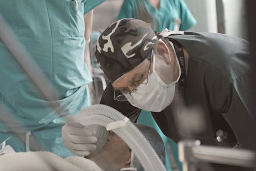 Doctors and nurses attending to a patient during a medical procedure indoors.
